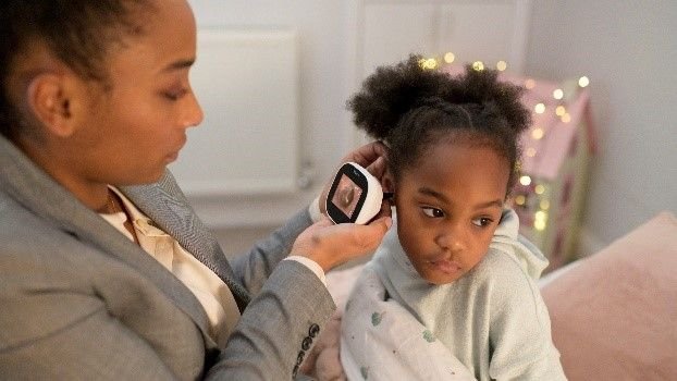 Doctor using innovative ear camera to examine child