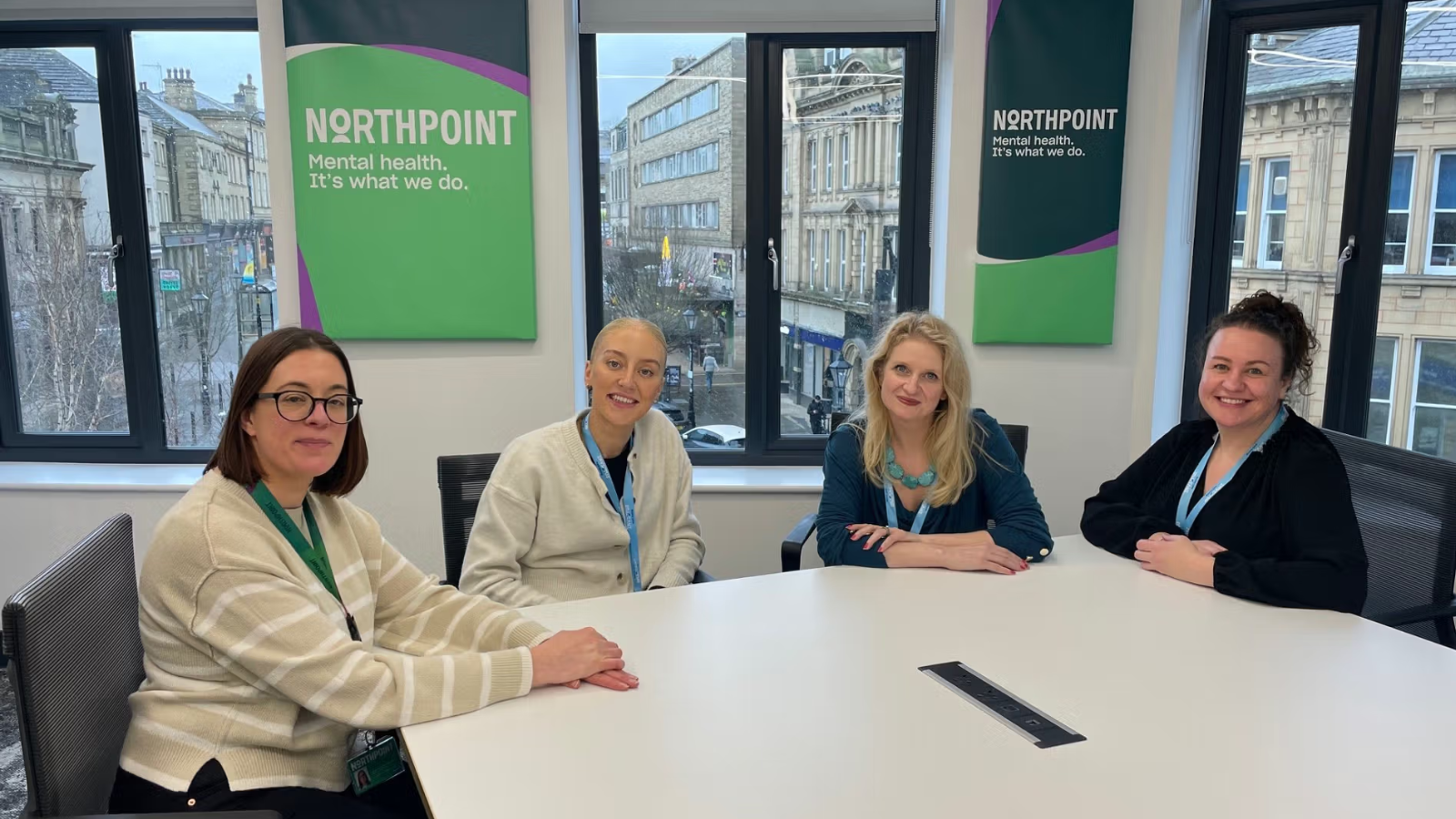 Image of people sat at a desk in front of Northpoint banner