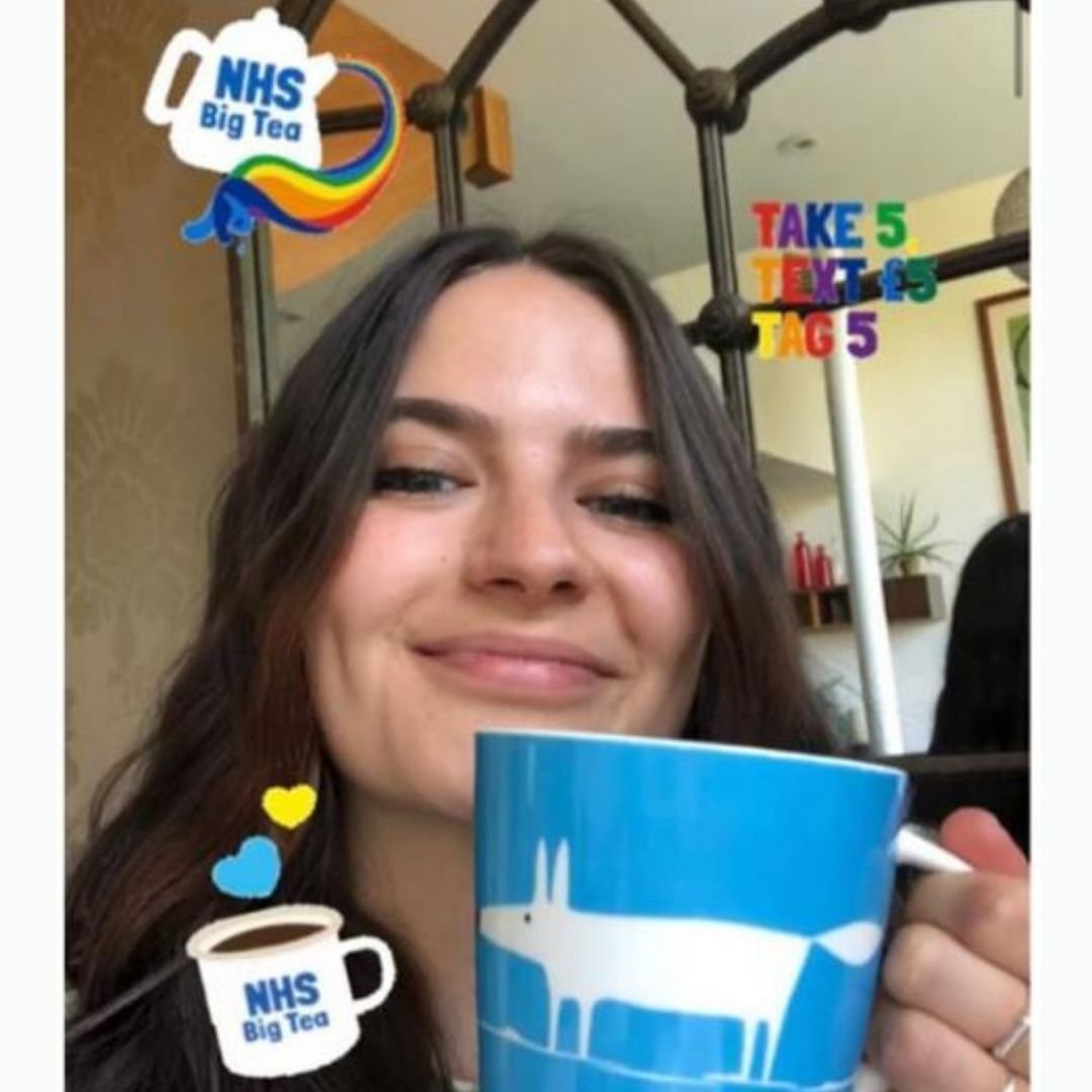 Woman drinking from an NHS Big Tea Party "Big Mug of Thanks" mug