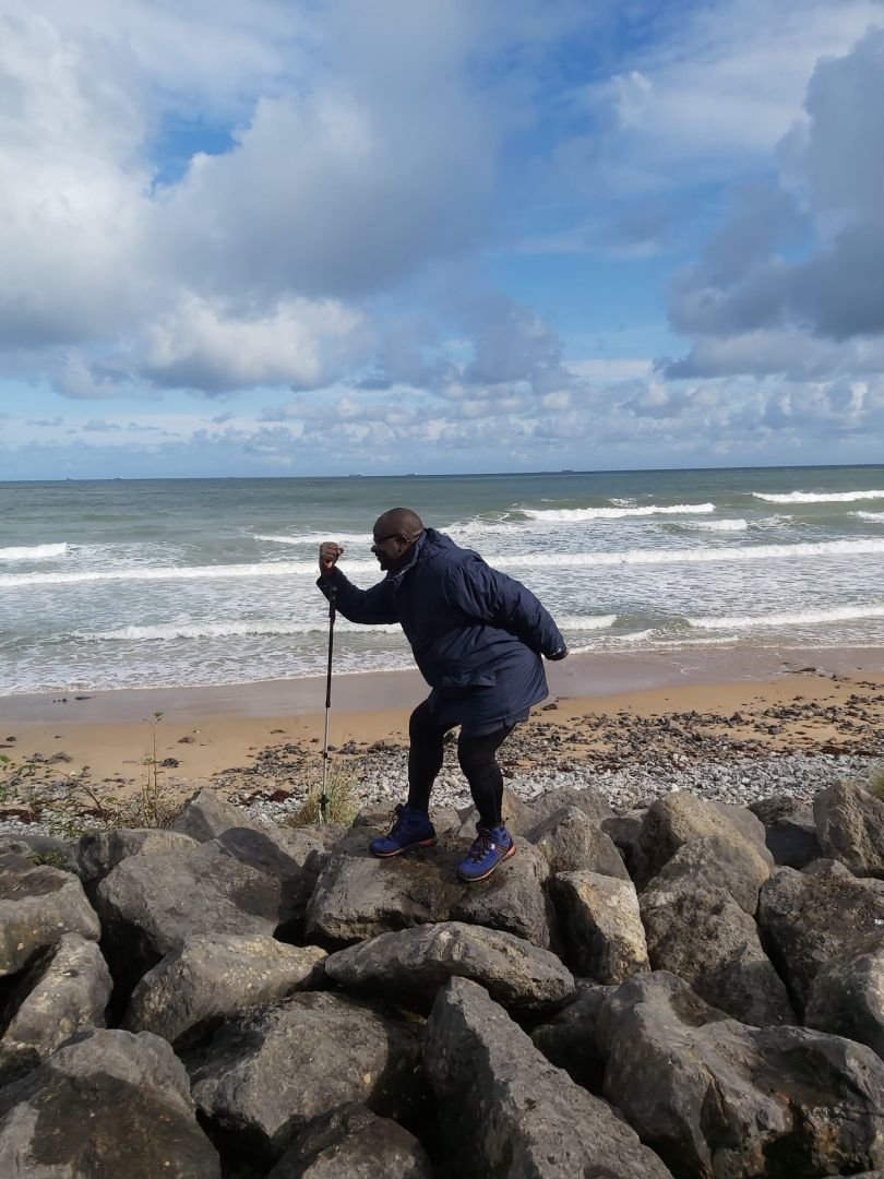 John Ebo on a rocky beach.jpg